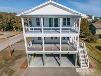 Two story home with large deck, ocean views, and walkway at 305 Matilda St, Edisto Beach, SC 29438