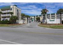 Inviting coastal condo building with gated entrance and ample parking at 3701 Docksite Rd # 320, Edisto Beach, SC 29438