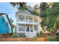 Two-story home with gray siding, white trim, and a front porch at 5232 E Dolphin St, North Charleston, SC 29405