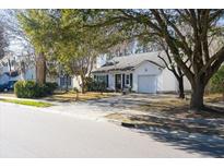 White house with a garage and mature trees in the front yard at 359 Muirfield Pkwy, Charleston, SC 29414