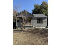 Gray craftsman style home with front porch and landscaped yard at 38 N Enston Ave, Charleston, SC 29403