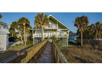 Elevated beach house with boardwalk path, two stories, and multiple balconies at 403 W West Ashley Ave, Folly Beach, SC 29439
