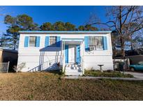 White single story home with blue accents and a small front yard at 429 Robin Dr, Goose Creek, SC 29445