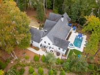 Aerial view of a home with pool and lush landscaping at 4991 Timber Race Crse, Hollywood, SC 29449