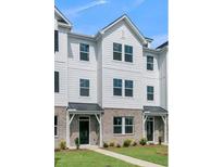 Three-story townhome with white siding, gray roof, and brick accents at 5112 Double Eagle, Summerville, SC 29485