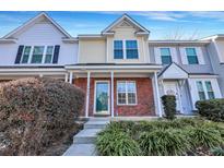 Brick front townhouse with a green door and landscaping at 7963 Shadow Oak Dr, North Charleston, SC 29406