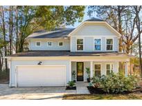Two-story light blue house with white garage and landscaping at 1216 Ashley Hall Rd, Charleston, SC 29407