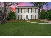 Two-story white house with gray shutters, manicured lawn, and a paved walkway at 1423 Oaklanding Rd, Mount Pleasant, SC 29464