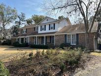 Brick house with a large front yard and mature trees at 19 Fort Royal Ave, Charleston, SC 29407