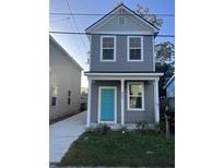 Two-story gray house with teal door, landscaping, and a paved driveway at 2023 Comstock Ave, North Charleston, SC 29405