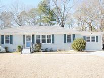 Ranch style home with gray exterior, landscaping, and a spacious lawn at 235 Blossom St, Goose Creek, SC 29445