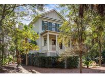 Two-story house with light green siding, dark shutters, and a wraparound porch at 2908 Old Drake Dr, Seabrook Island, SC 29455
