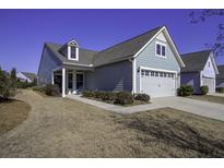 Gray siding house with two-car garage and manicured lawn at 304 Bloomington Way, Summerville, SC 29486