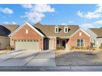 Brick home with two-car garage and landscaped yard at 482 Hidden Meadow Ln, Summerville, SC 29486