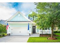 Charming light teal house with white trim, landscaping, and a two-car garage at 5317 Birdie Ln, Hollywood, SC 29449