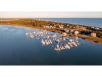 Aerial view of waterfront homes and a marina with many boats at 67 W We 10Th St # A-8, Folly Beach, SC 29439