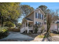 Two-story house with a front porch and a driveway at 882 Sedge Ct, Charleston, SC 29412