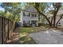 Two-story house with gray siding, walkway, and fenced yard at 1617 Jessamine Rd, Charleston, SC 29407