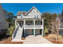 Two-story house with a front porch, two-car garage, and landscaping at 2084 Amenity Park Dr, Mount Pleasant, SC 29466