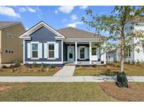 Charming craftsman style home with blue siding, light blue shutters, and a welcoming front porch at 349 Trailmore Ln, Summerville, SC 29486