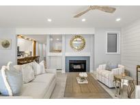 Bright living room with fireplace, comfortable seating, and access to deck at 4995 Green Dolphin Way, Kiawah Island, SC 29455