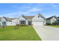 Charming one-story home with gray siding, a white garage door, and a manicured lawn at 6176 Wilkes Pond Dr, Hollywood, SC 29449