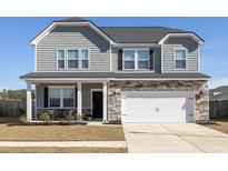Two-story house with gray siding, stone accents, and a white garage door at 705 Squire Pope Rd, Summerville, SC 29486