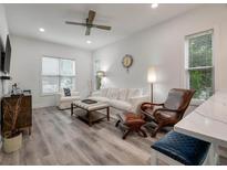 Bright living room features hardwood floors, comfy seating, and a stylish coffee table at 7311 Indigo Palms Way, Johns Island, SC 29455