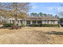 Charming single-story brick home featuring a covered front porch and well-maintained landscaping at 101 Winston Cir, Summerville, SC 29485