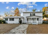 Charming two-story home with painted brick and metal roof at 213 Rose Ave, Walterboro, SC 29488