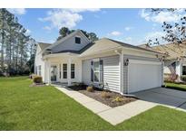 Charming single-story home featuring a two-car garage, well-manicured lawn, and inviting curb appeal at 241 Sea Lavender Ln, Summerville, SC 29486