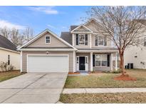 Charming two-story home with a two-car garage and a well-maintained front yard at 2426 Stadium Dr, North Charleston, SC 29406