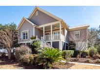 Charming two-story house with a front porch and well-manicured landscaping at 2517 Charter Oaks Dr, Mount Pleasant, SC 29466