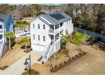 Beautiful home with a two-story entry, solar panels, a well-manicured yard, and a private pool at 2936 Tranquility Rd, Mount Pleasant, SC 29466