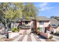 Charming townhome with brick-lined driveway and lush landscaping in a desirable neighborhood with mature trees at 313 Lapwing Ln, Mount Pleasant, SC 29464