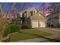 Two-story house with a landscaped lawn, two-car garage, and inviting porch at 332 Clayton Dr, Charleston, SC 29414