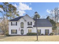Two story white house with black shutters, a large front yard, and a lamp post at 7897 Sabalridge Dr, North Charleston, SC 29418