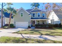 Charming two-story home with manicured lawn, attached garage, and welcoming front porch at 8623 Woodland Walk, North Charleston, SC 29420