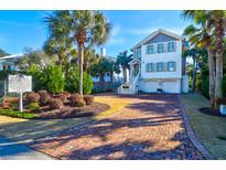 Beautiful two-story home features palm trees, lush landscaping, and a brick driveway at 120 Charleston Blvd, Isle of Palms, SC 29451