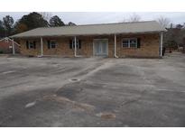 Inviting single-story brick house with a metal roof and a spacious parking lot at 1382 Doctor Evans Rd, Moncks Corner, SC 29461