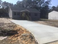 Charming single-story home with gray siding, black shutters, and a new concrete driveway at 183 Waverly Rd, Walterboro, SC 29488
