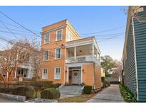 Charming three-story home featuring a welcoming front porch and well-maintained landscaping at 234 Rutledge Ave # D, Charleston, SC 29403