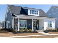 Charming home featuring a welcoming front porch, stylish decor, and meticulously landscaped front yard at 332 Clearpath Dr, Summerville, SC 29486