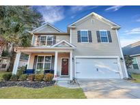 Charming two-story home with tan siding, attached garage, and inviting front porch at 3632 Locklear Ln, Mount Pleasant, SC 29466