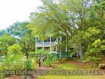 Charming custom Charleston home with marsh views surrounded by lush greenery on a spacious 1.3-acre lot at 8869 Marsh Aire Ln, Edisto Island, SC 29438