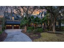 Beautiful two-story home with a brick exterior, manicured landscaping, and a two-car garage at 15 Watroo Pt, Daniel Island, SC 29492