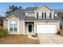 Charming two-story home featuring a two-car garage, black door, and neutral-toned siding at 215 Evesham Dr, Summerville, SC 29485