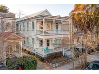 Charming two-story home with a porch, balcony and aqua-painted doors, exuding curb appeal at 243 Rutledge Ave, Charleston, SC 29403