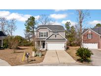 Charming two-story home with gray siding, a two-car garage, and a well-maintained front yard at 3426 Kirkwall Dr, Summerville, SC 29485