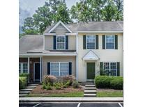 Charming townhome featuring a well-manicured lawn and classic architecture with lovely dark shutters at 369 Kelsey Bouevard Blvd, Charleston, SC 29492